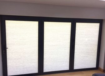 Pleated blinds fitted on bifold doors at a house in Exeter.